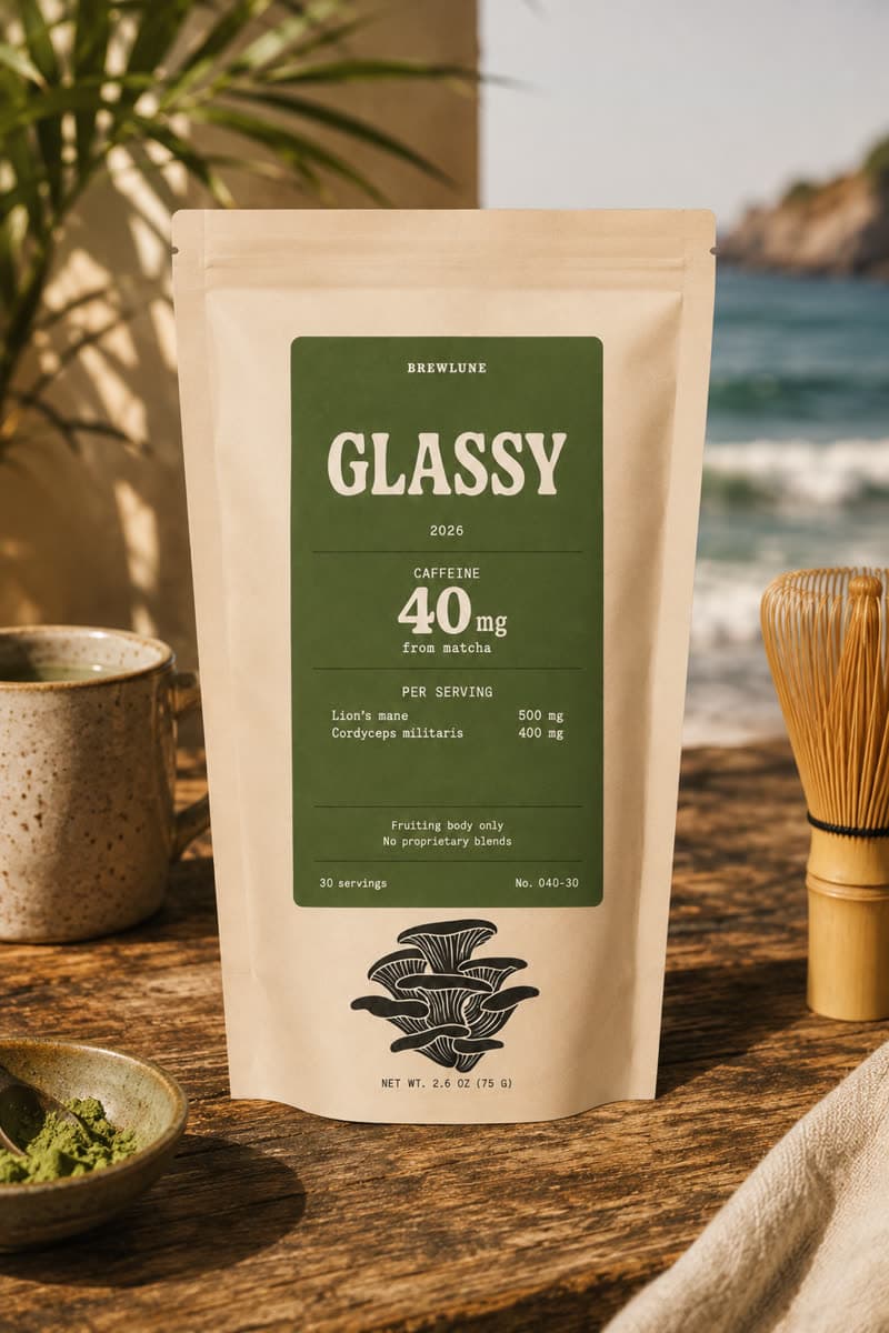Glassy pouch on a wooden table beside a matcha whisk, its dose table printed on the front
