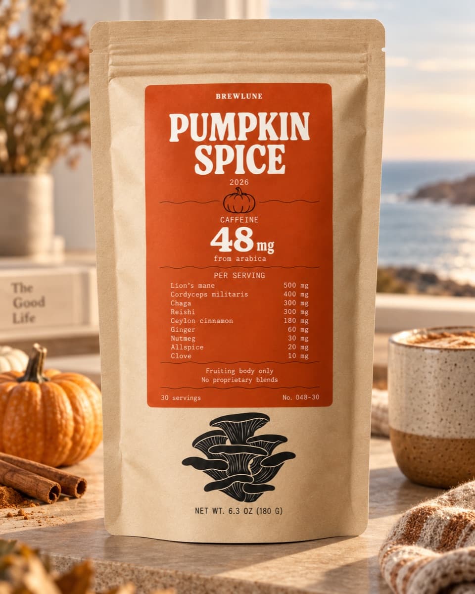Brewlune Pumpkin Spice mushroom coffee pouch on a kitchen counter beside a pumpkin and cinnamon sticks, its dose table printed on the front